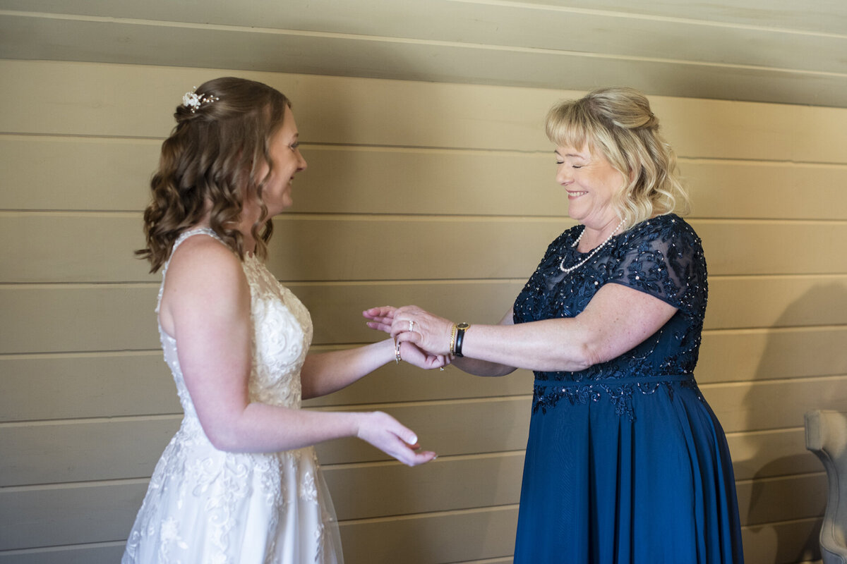 Bride and mother getting ready for wedding