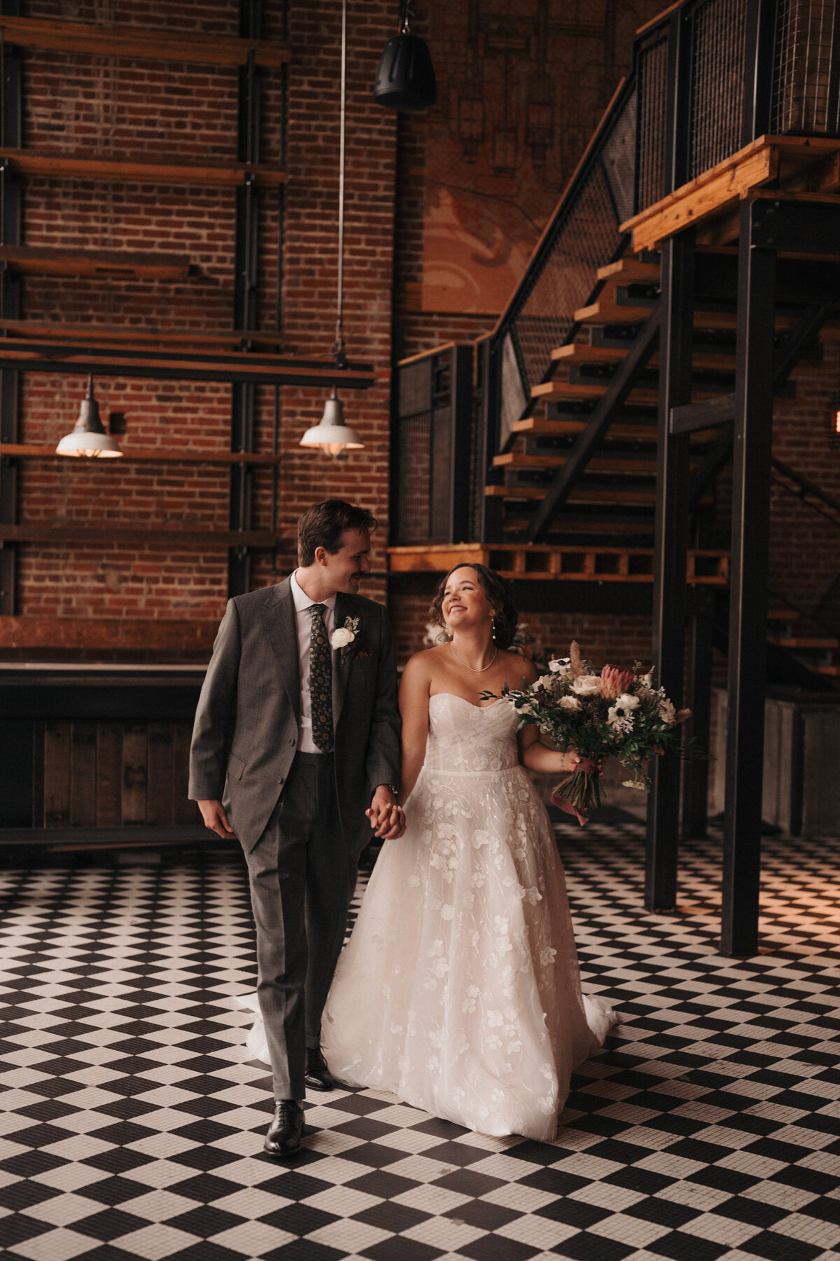 Bride and groom holding hands in Greensboro, NC.