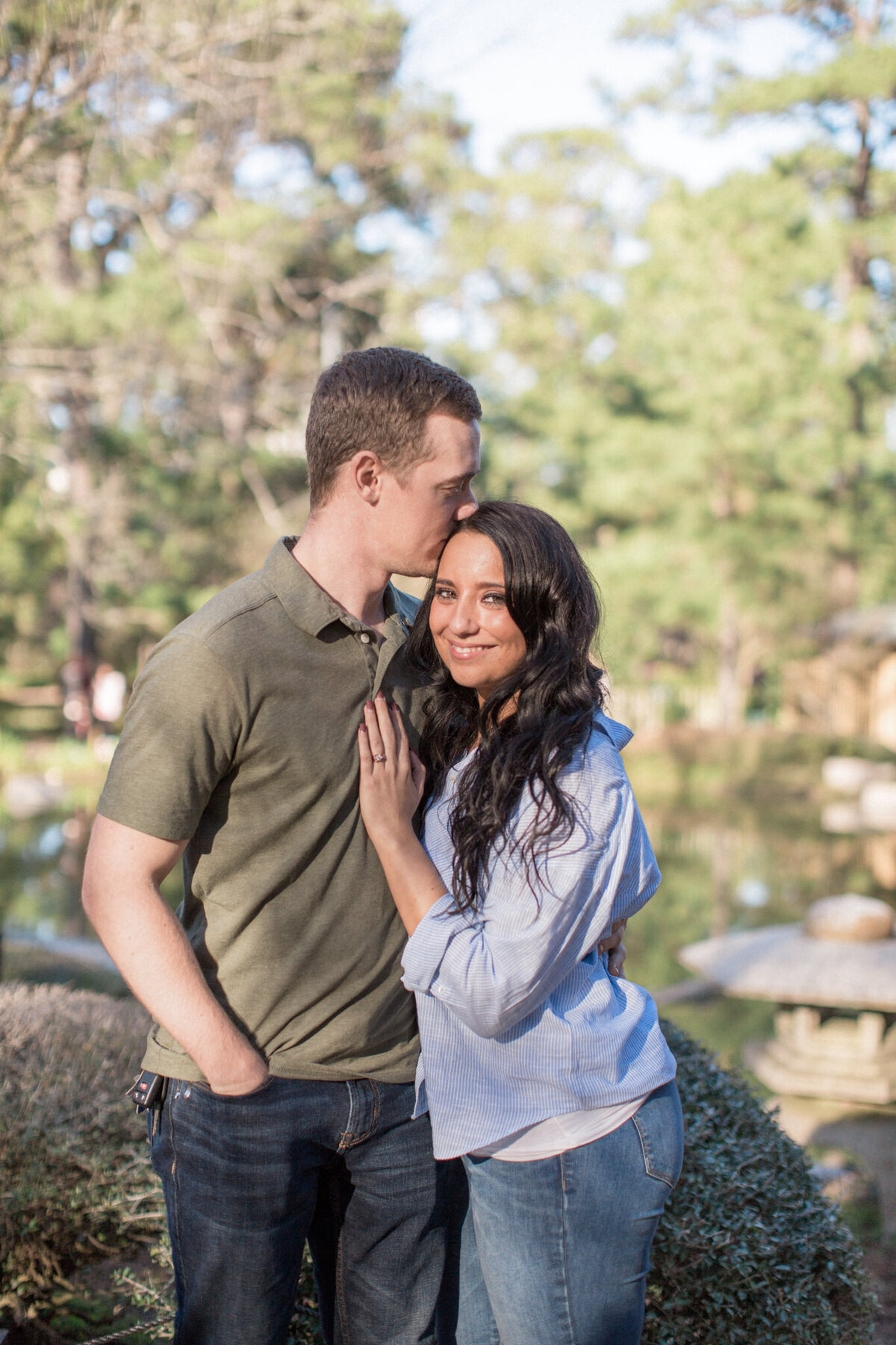 A couple poses for a photo just after she said yes to his proposal