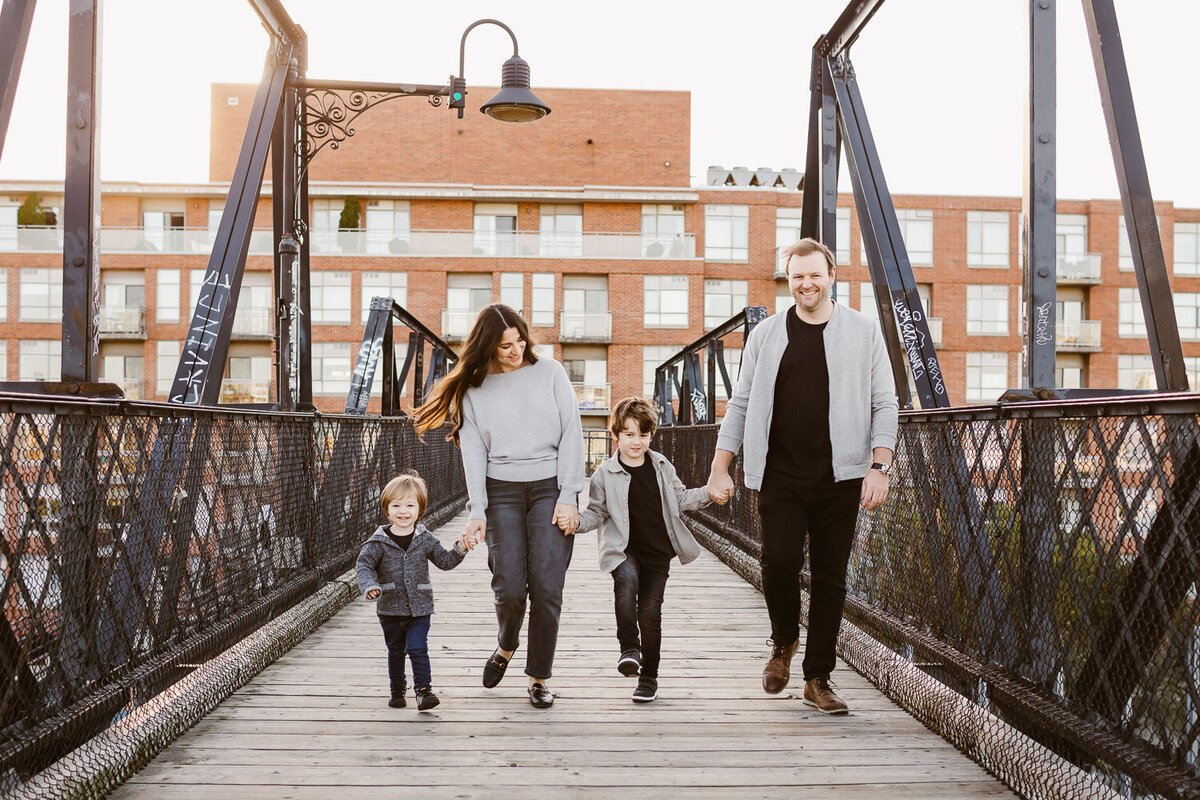 family of 4 walking on wallace bridge in toronto