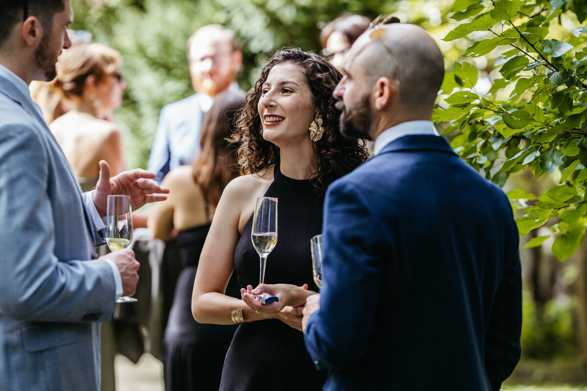 Wedding guests smiling and talking during celebration