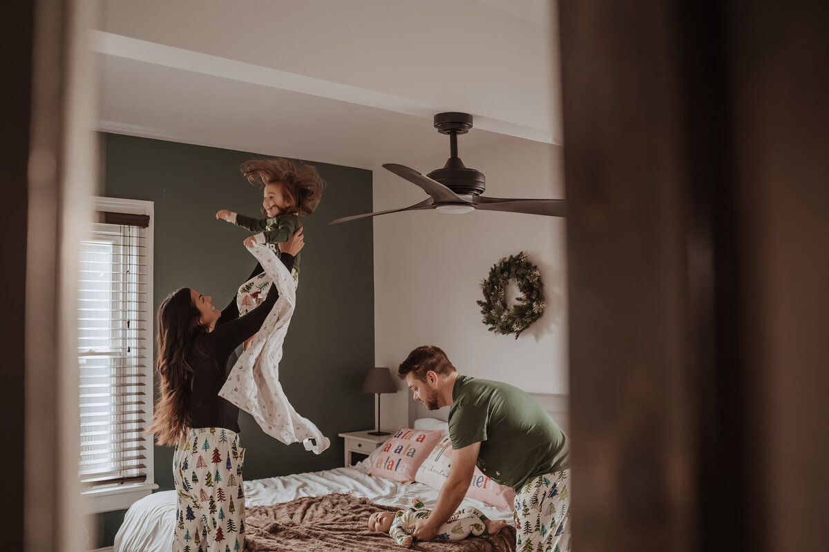 Family playing in bedroom