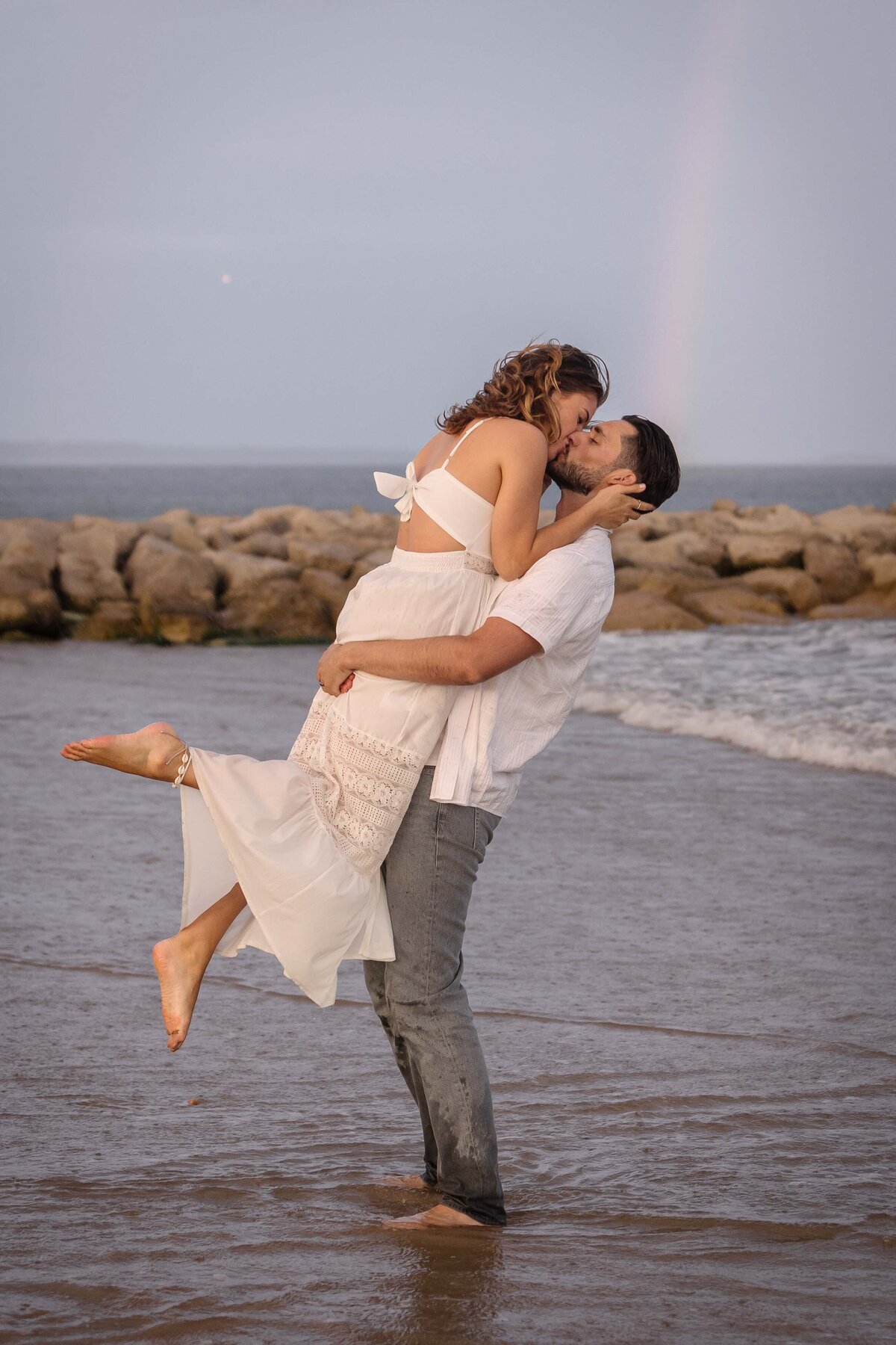 A couple on the seashore at sunset in Dorset