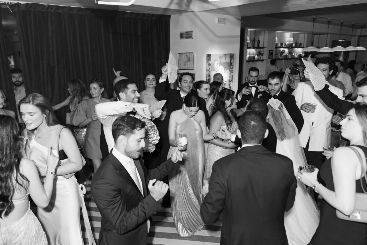 Wedding guests laughing and mingling during reception at Soho House Rome