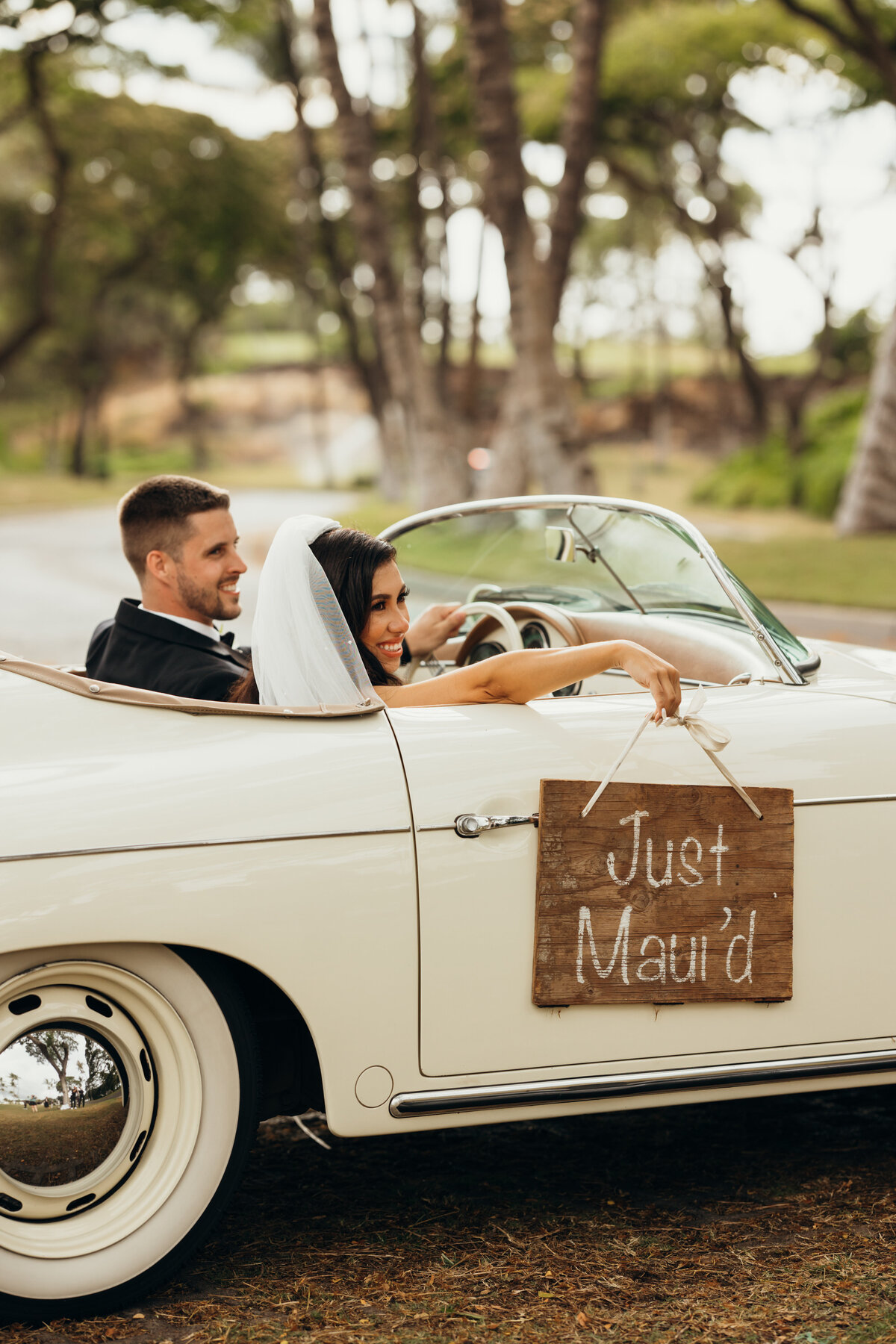 Maui Wedding Photographer captures bride and groom leaving wedding in vintage car