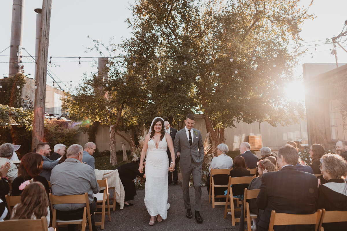Bride and groom walk down the aisle after their wedding ceremony in Blanc Denver.
