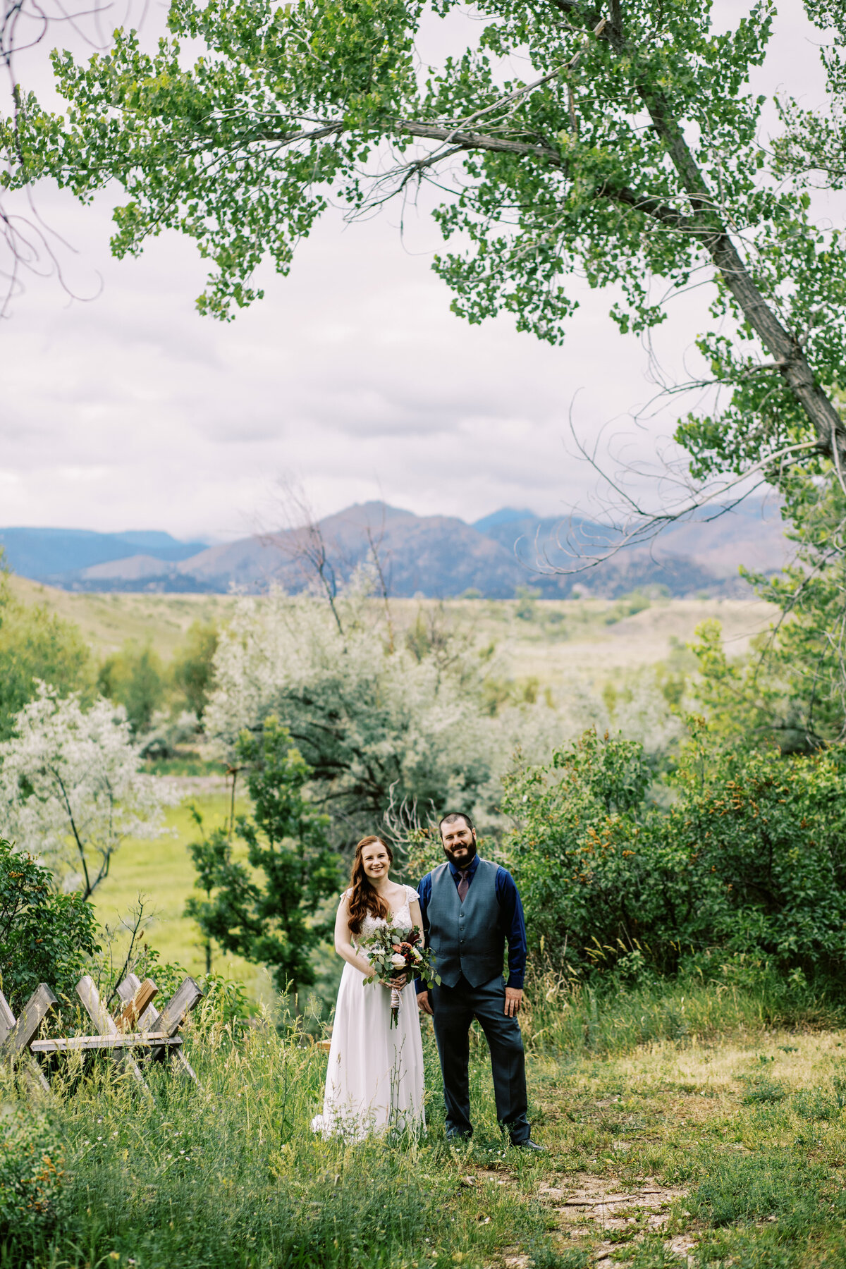 Lone Hawk Farm wedding couple pose by mountains