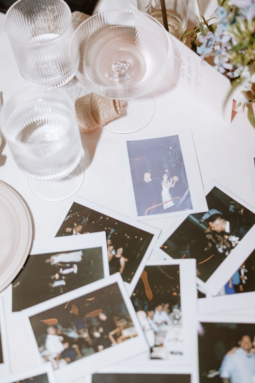 Flat lay photo of polaroid pictures taken at a wedding