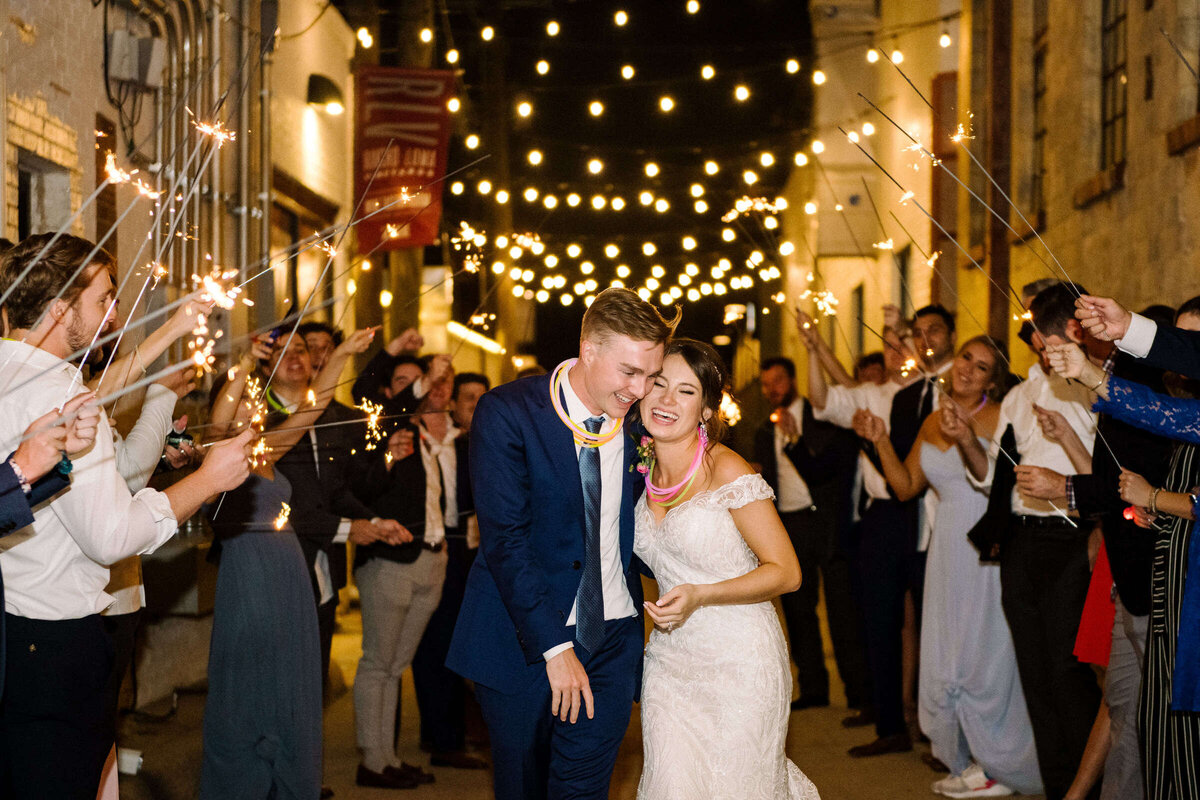 Bride and groom make their exit with glow stick necklaces and sparklers in North Texas