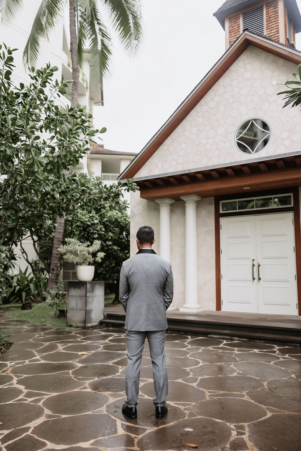 Groom waiting in front of chapel for first look at four seasons Oahu