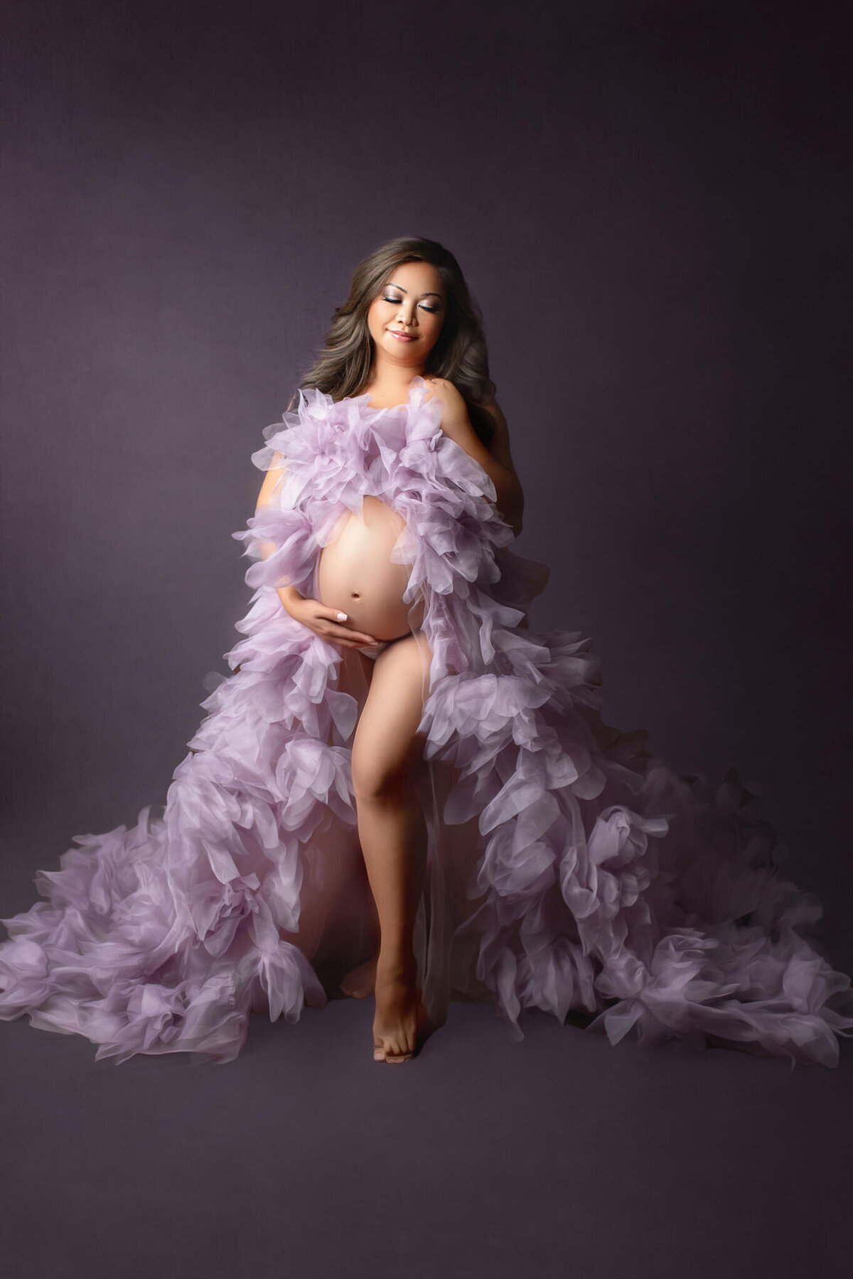 expecting mother wearing beautiful, full tulle purple gown, posing for hamilton maternity photographer
