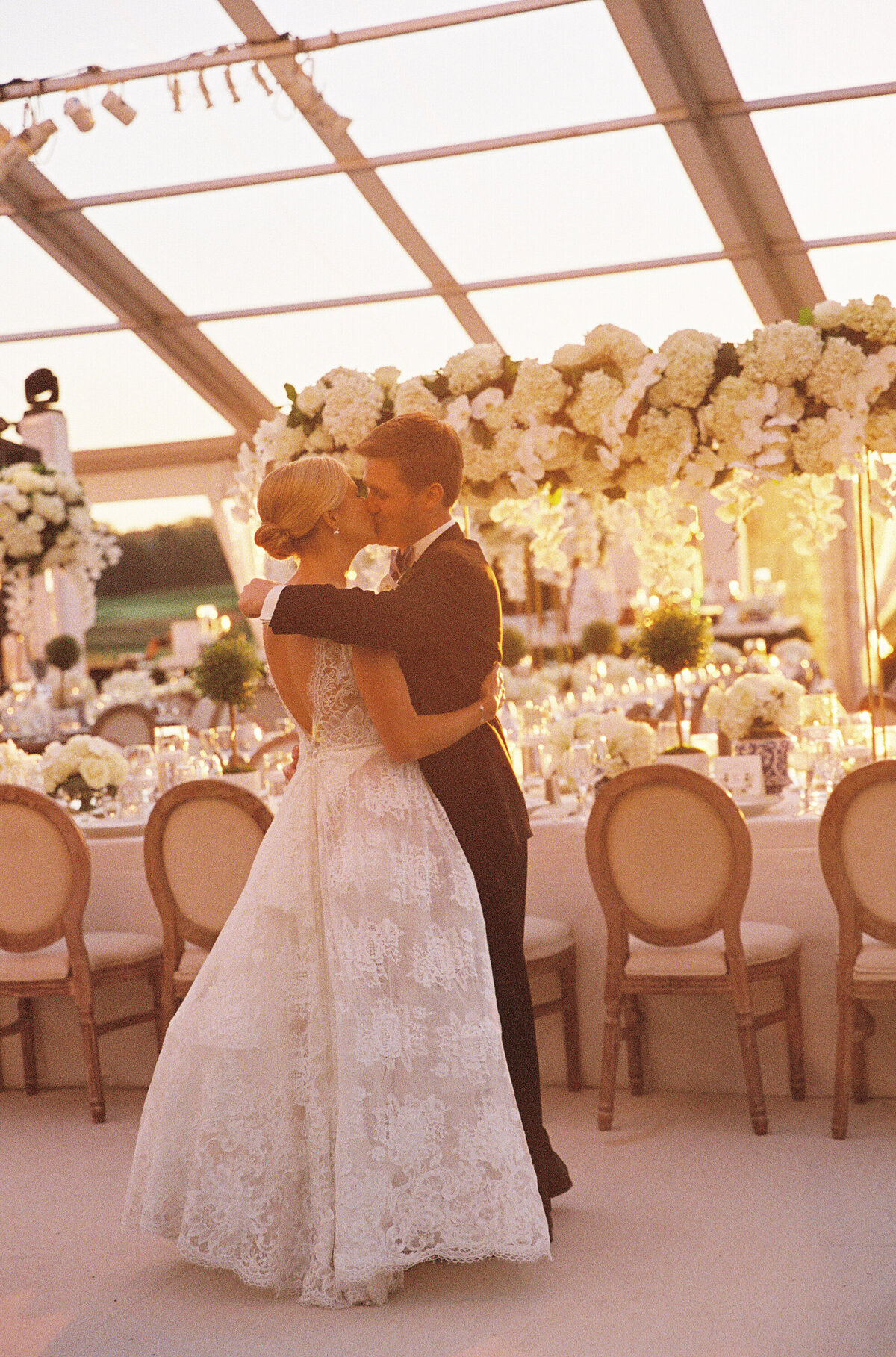 Bride and groom kissing at the reception at the Onwentsia country club. 