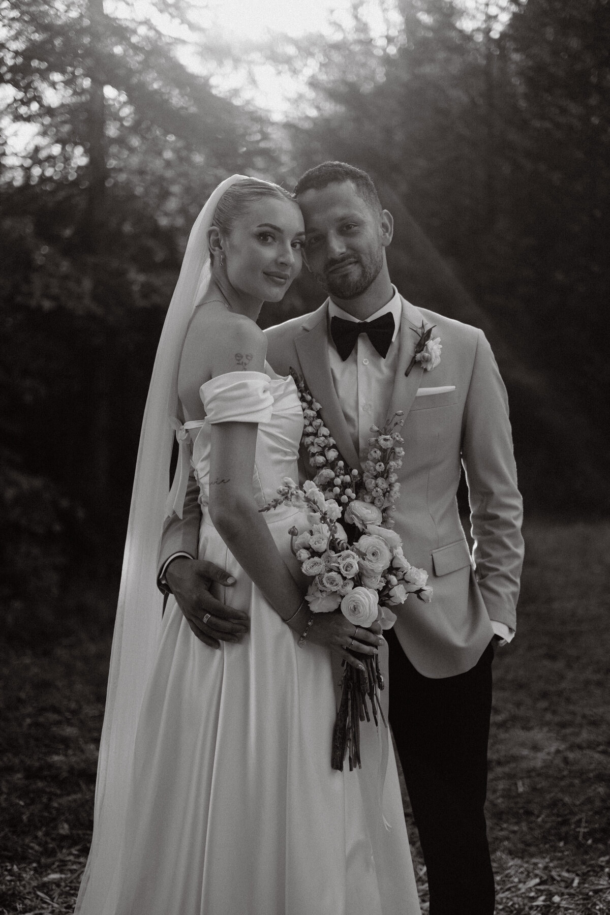 classic portrait of newlyweds with sun shining behind them