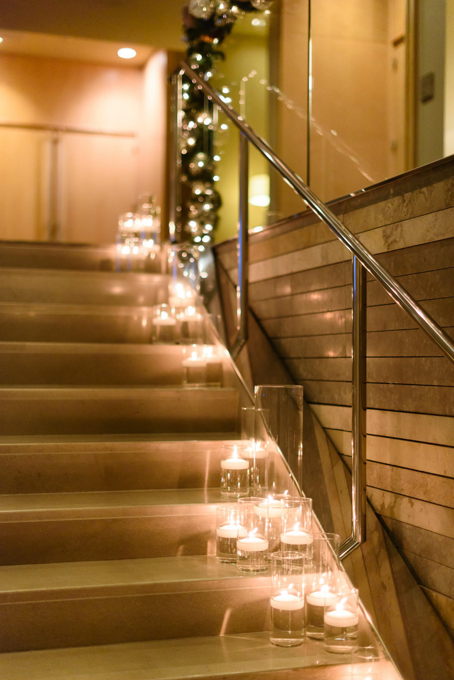 Beautiful and simple wedding staircase lined with the soft glow of candles