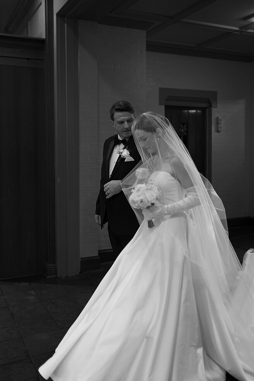 bride and her father walking into church