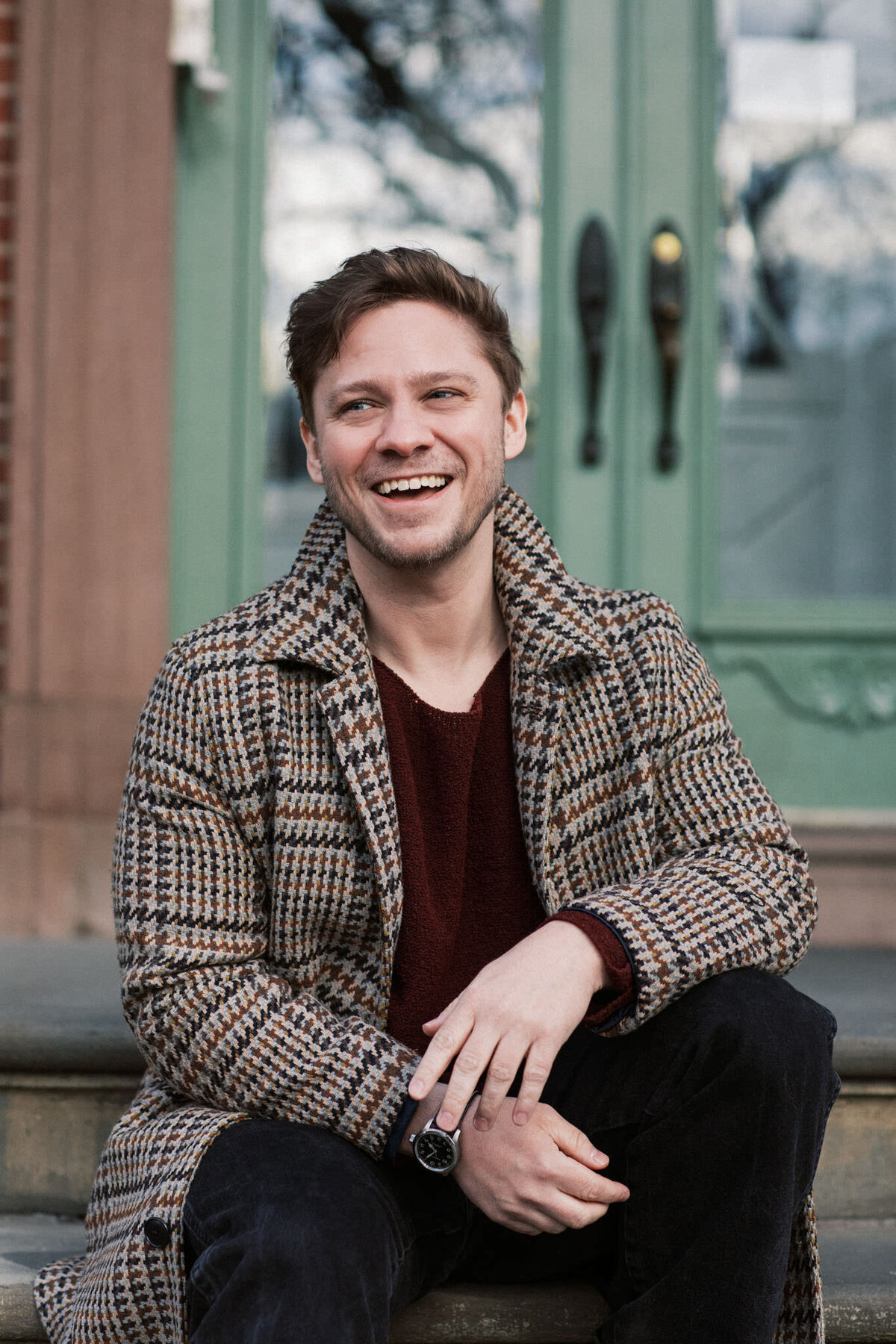 portrait of journalist t jennings brown sitting on a stoop in brooklyn