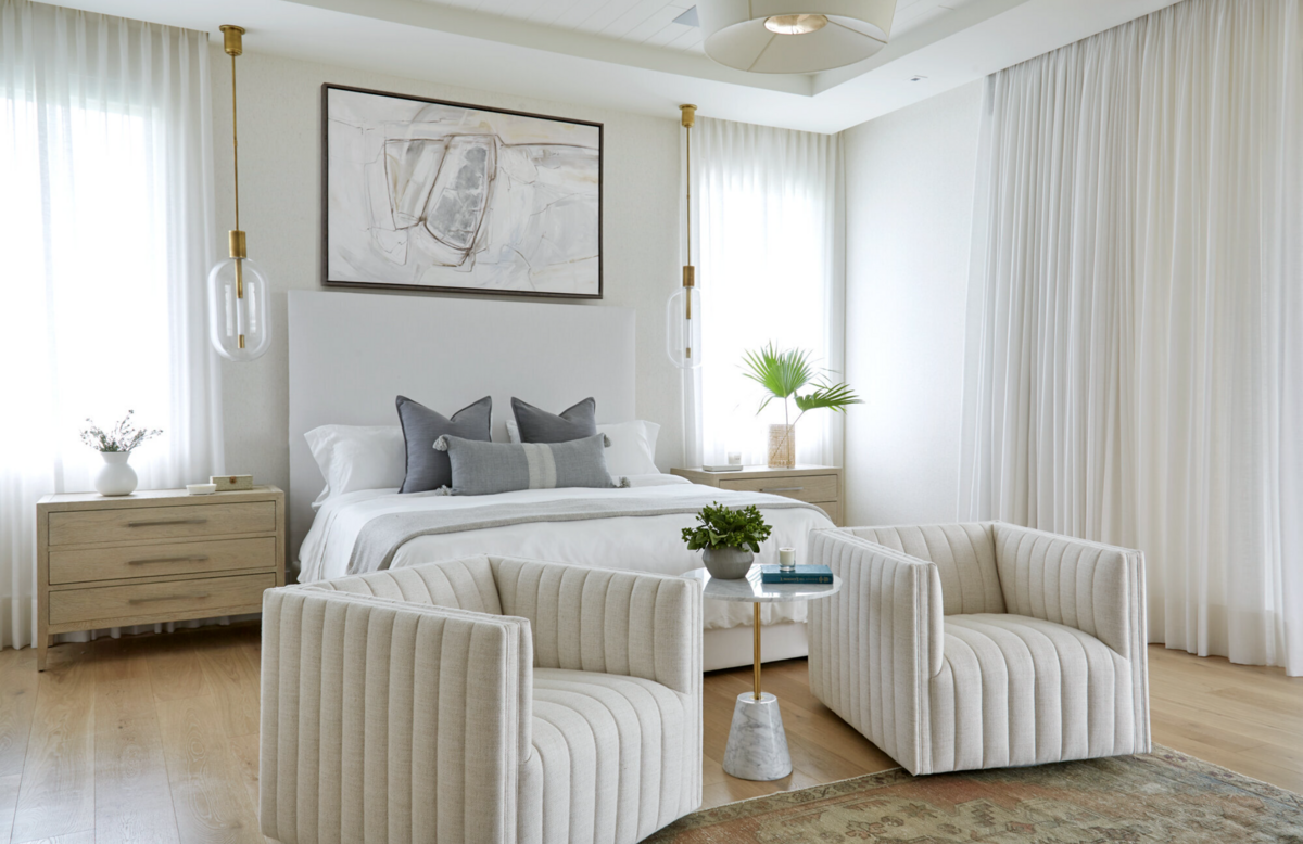 Bedroom interior with soft white lien curtains, white upholstered bed and white flax linen swivel chairs