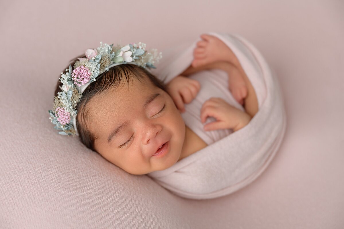 Newborn portrait with flower crown in professional photography studio located in West Lake Worth, FL.