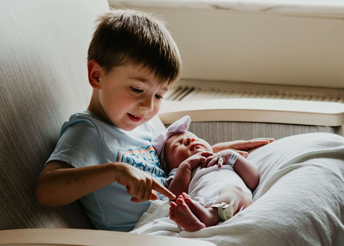 Brother and sister in a hospital bed, captured by a Pittsburgh newborn photographer.