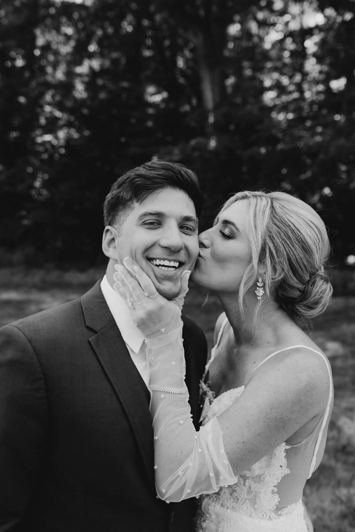 Groom smiling while holding his bride close during their South Bend wedding shoot.