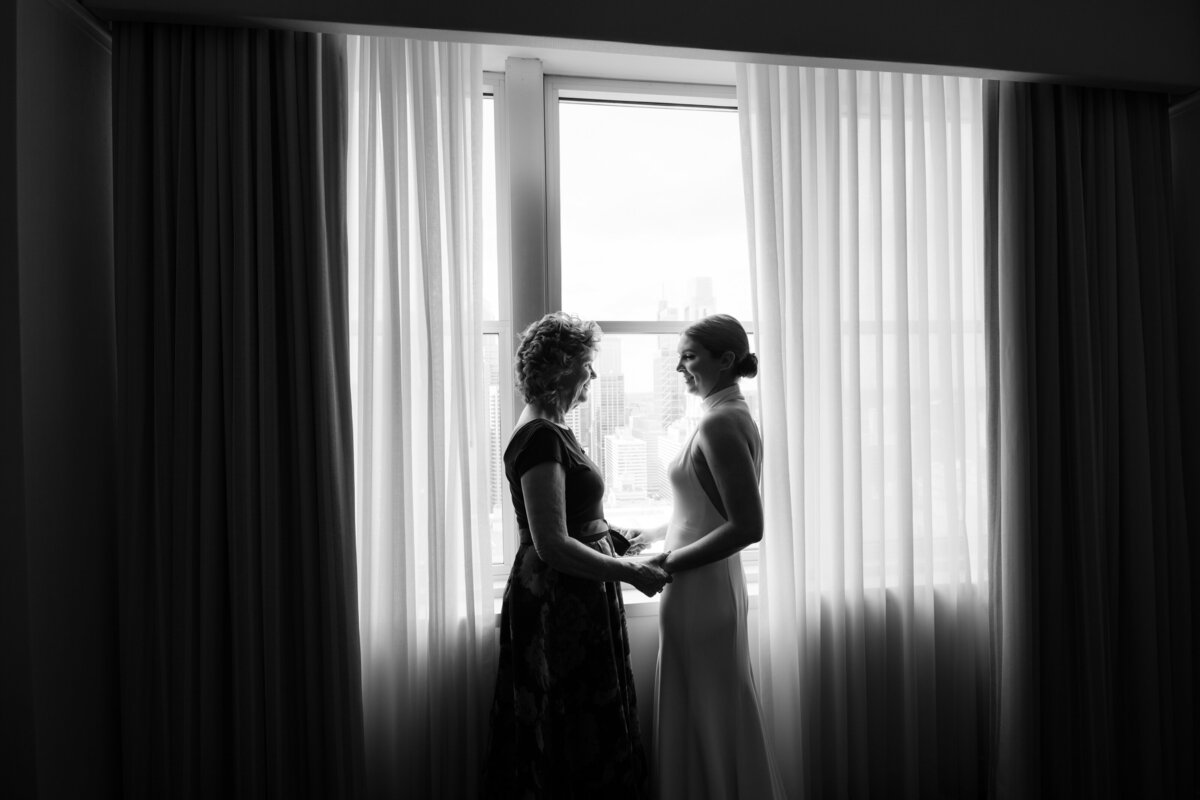 Bride and her mom sharing a moment on her wedding day 