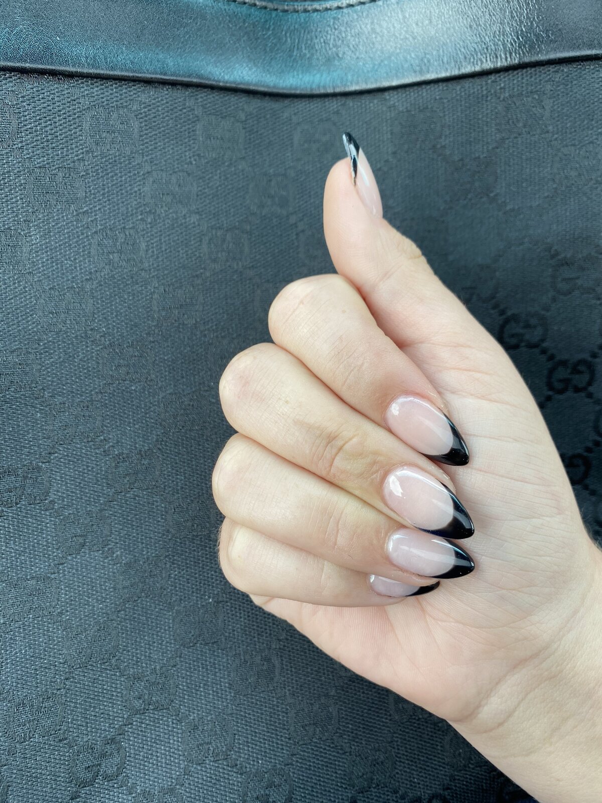 Woman's hands with black painted nail tips