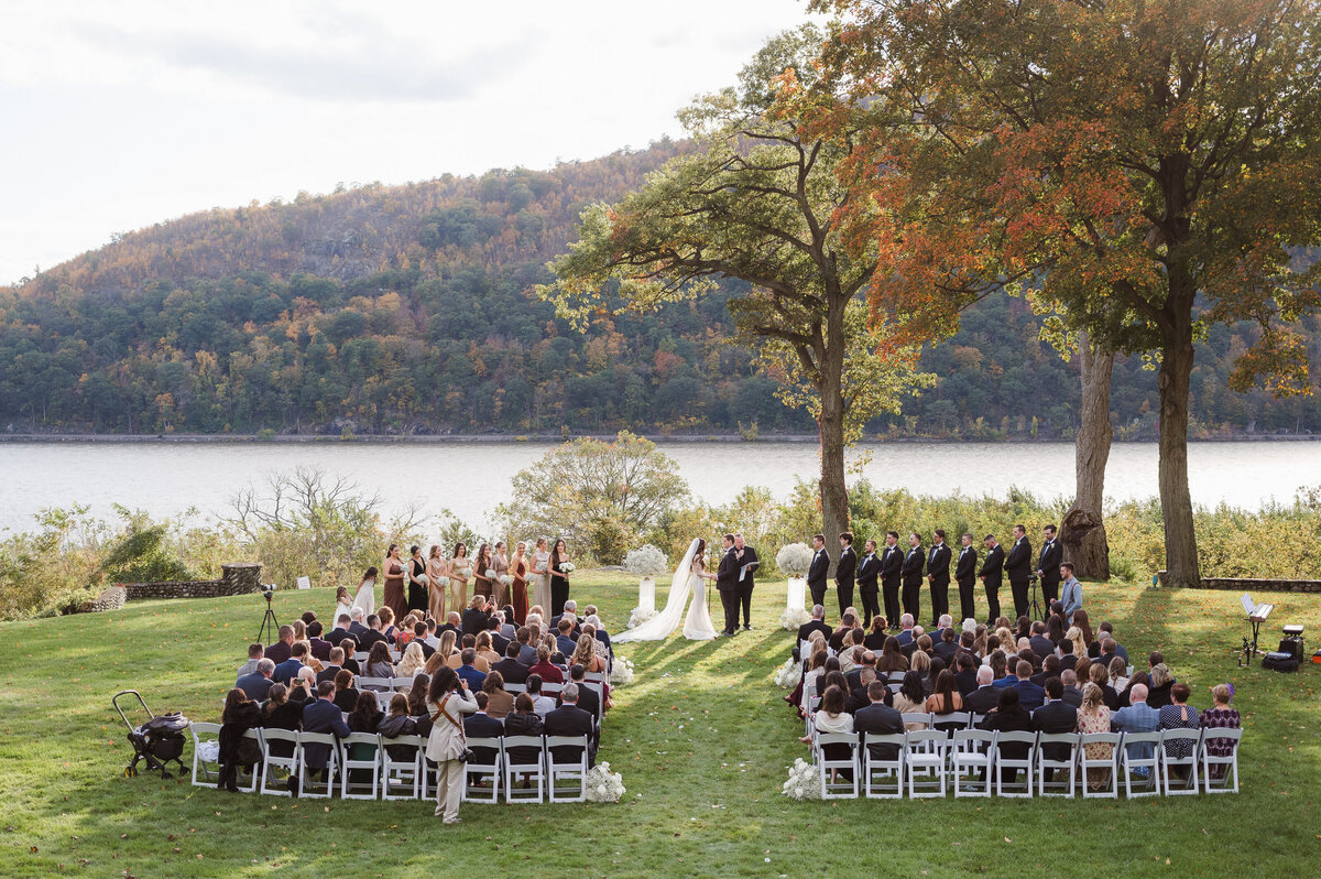 Outdoor ceremony photo in front of the Hudson River by Suess Moments photography