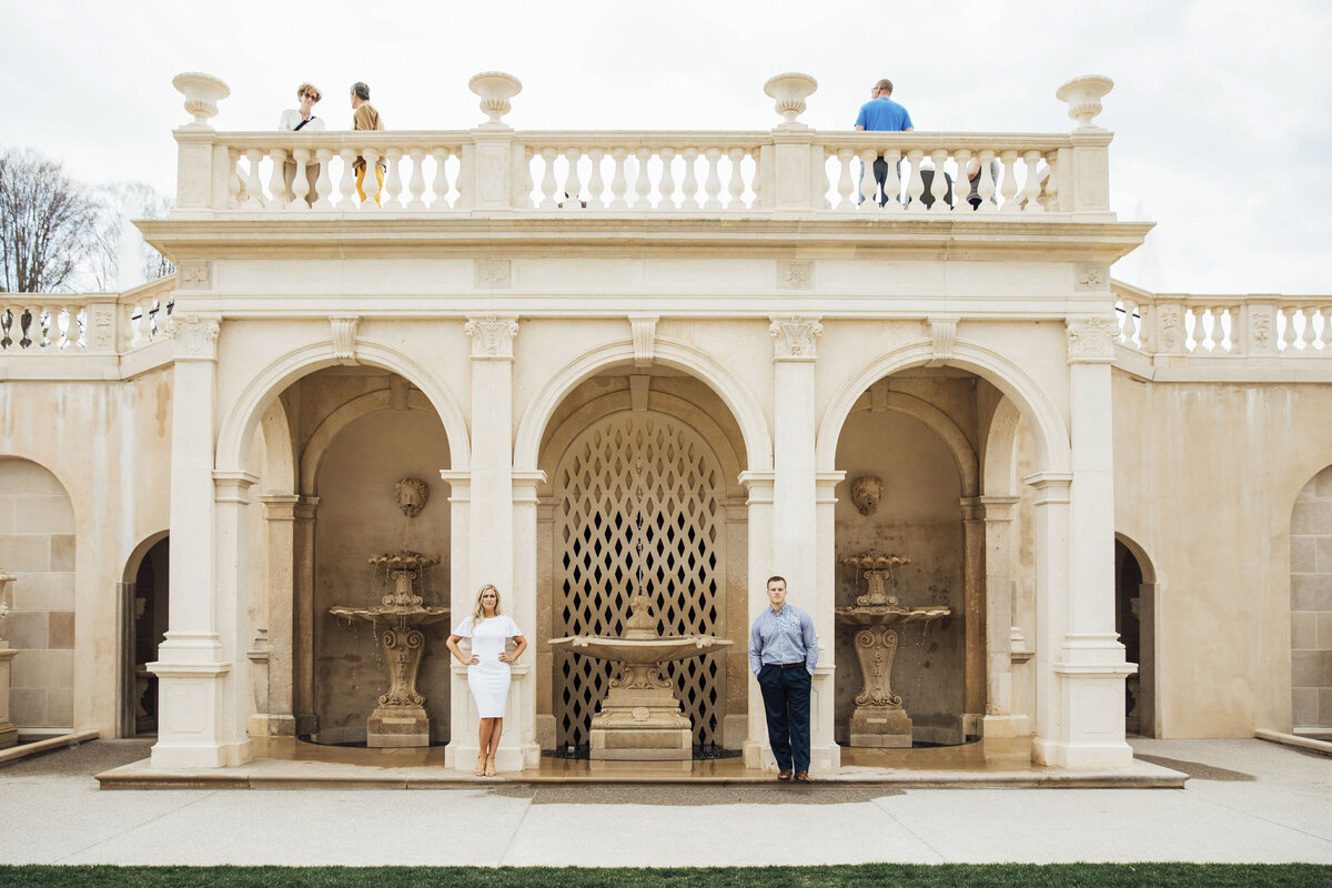 Trendy couple by architectural structure during spring engagement shoot at Longwood Gardens in Kennett Square Pennsylvania