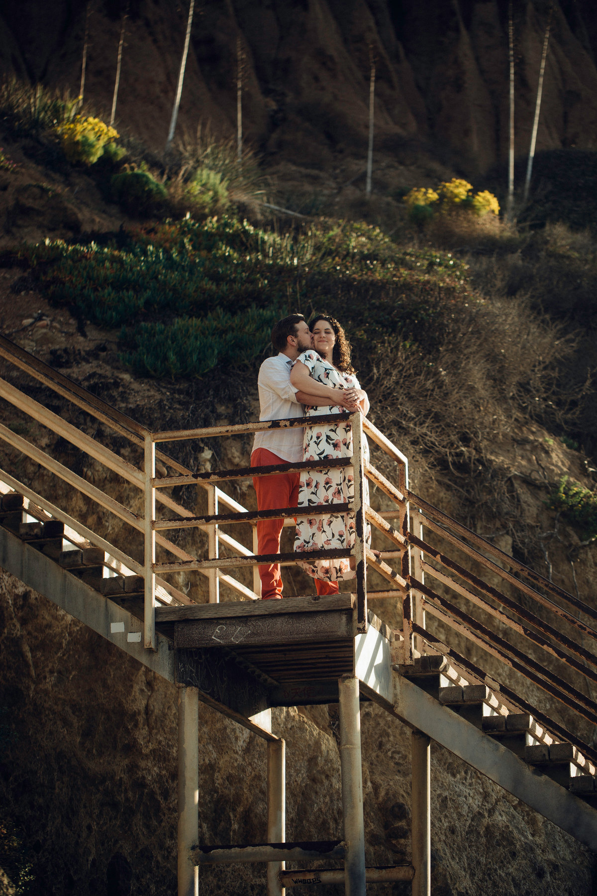 Engagement Photograph Of  Man Hugging a Woman From The Back On a Staircase Los Angeles