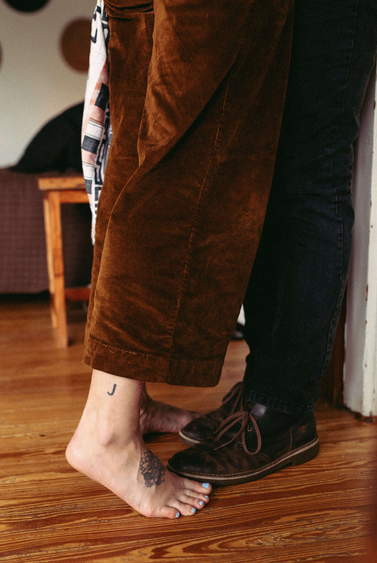 detail shot of couples shots & feet while kissing.  girl is on tiptoes