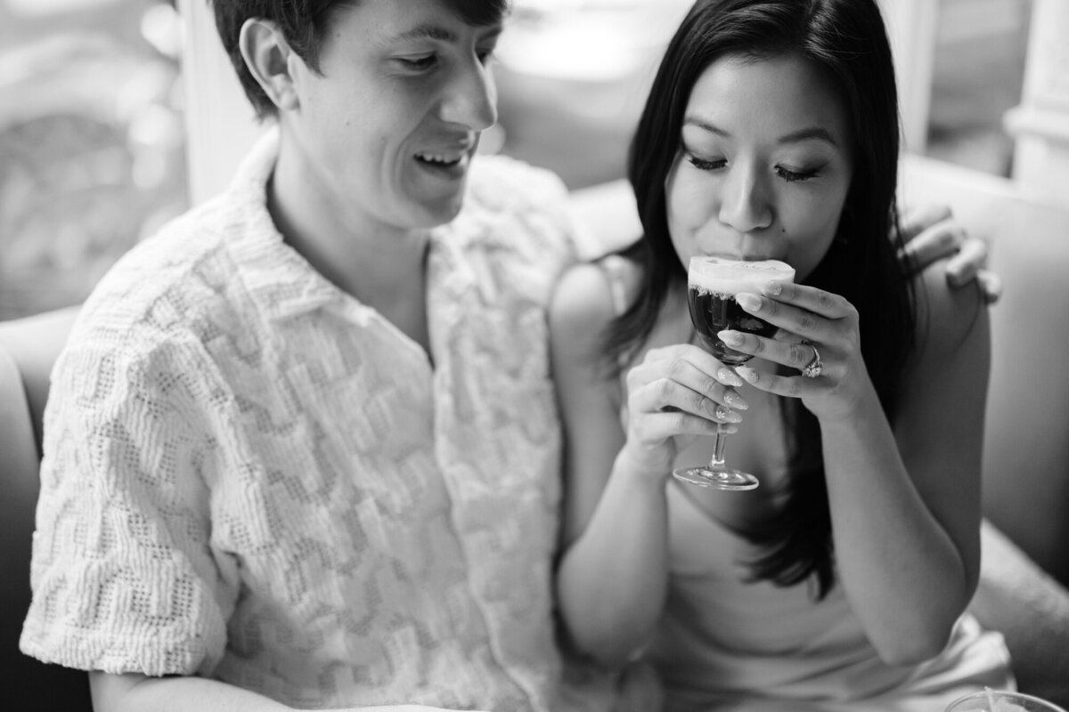 Black and white photo of a couple during their NYC engagement session at Dante West Village, featuring the Honey Bee cocktail and a cozy, romantic vibe.