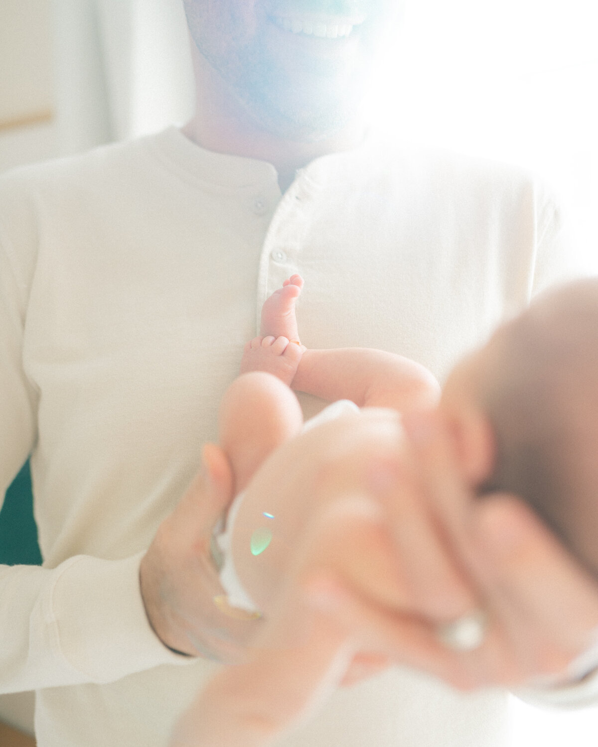 Father holding newborn baby by Oklahoma City Photographer Courtney Cronin