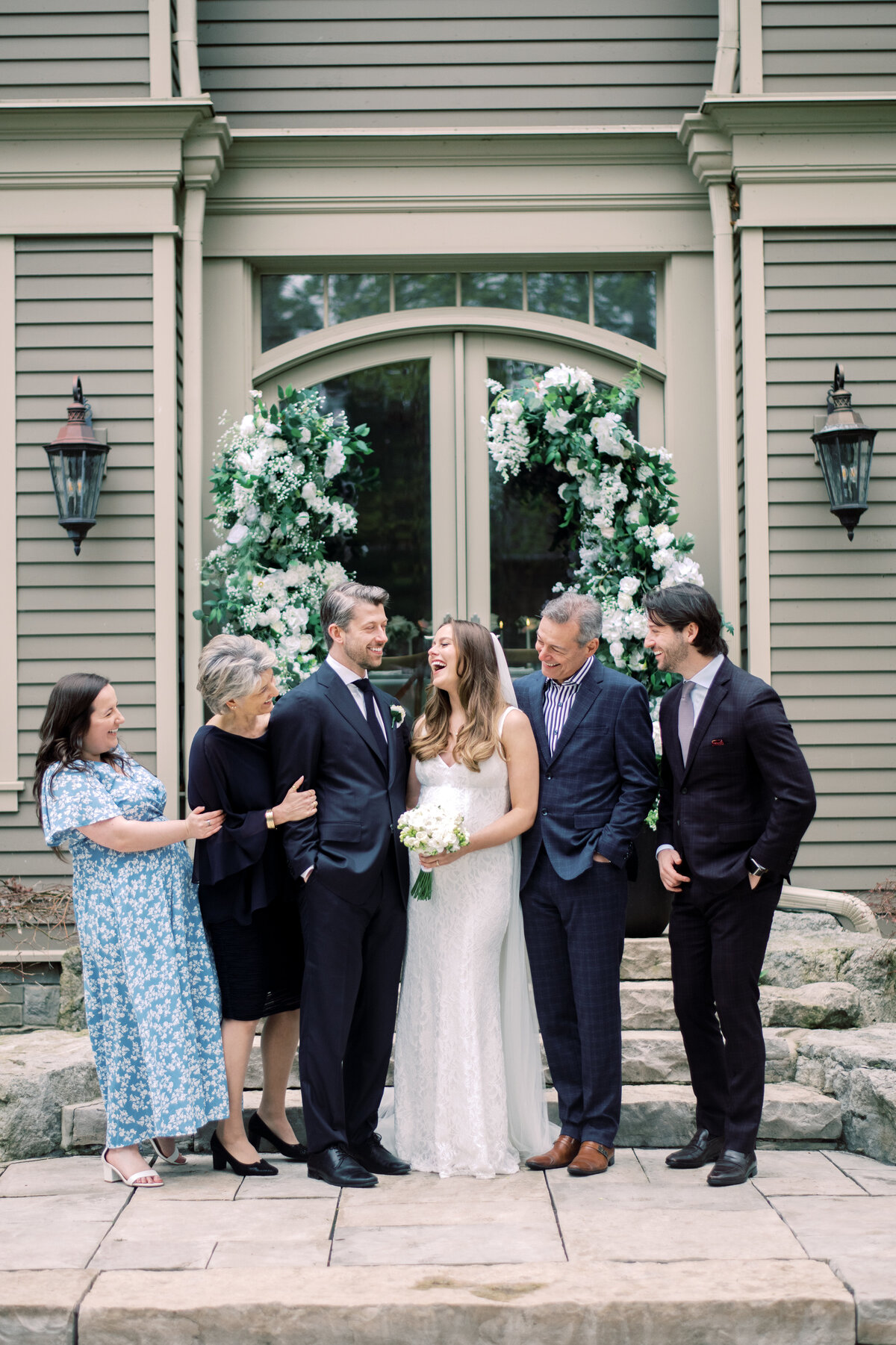 Grooms family share a laughing moment during family portraits.