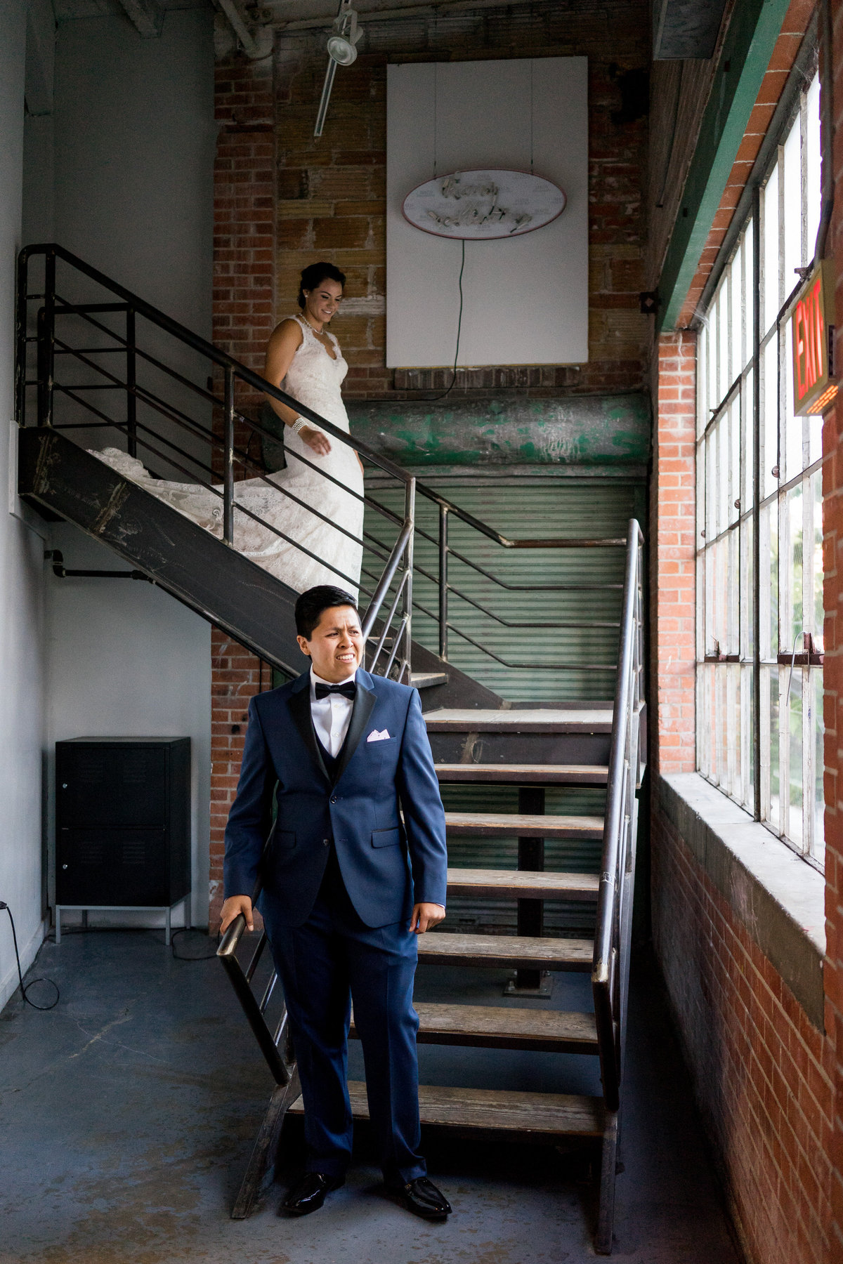 Bride walking down stairs for first look at Brick at Blue Star wedding venue by Expose the Heart