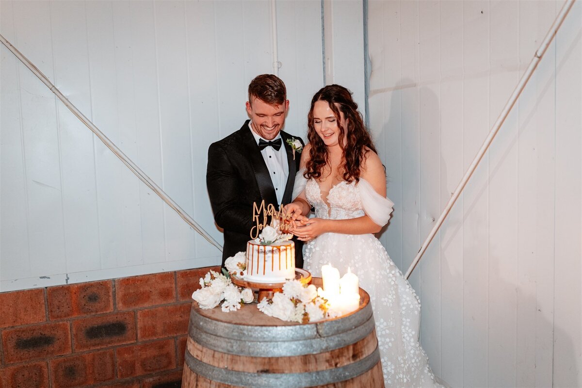 A charming moment captured as the couple shares a joyous dance amidst their wedding reception festivities.
