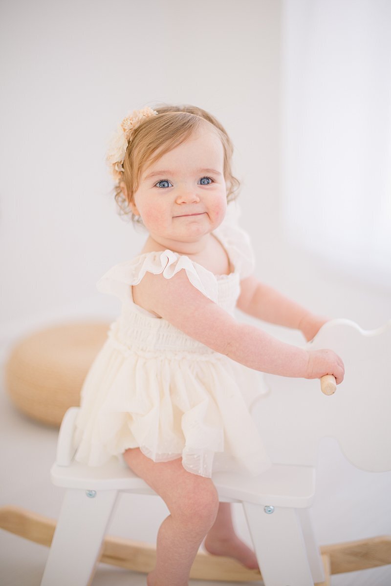 Little girl riding rocking horse by Fairfield photographer