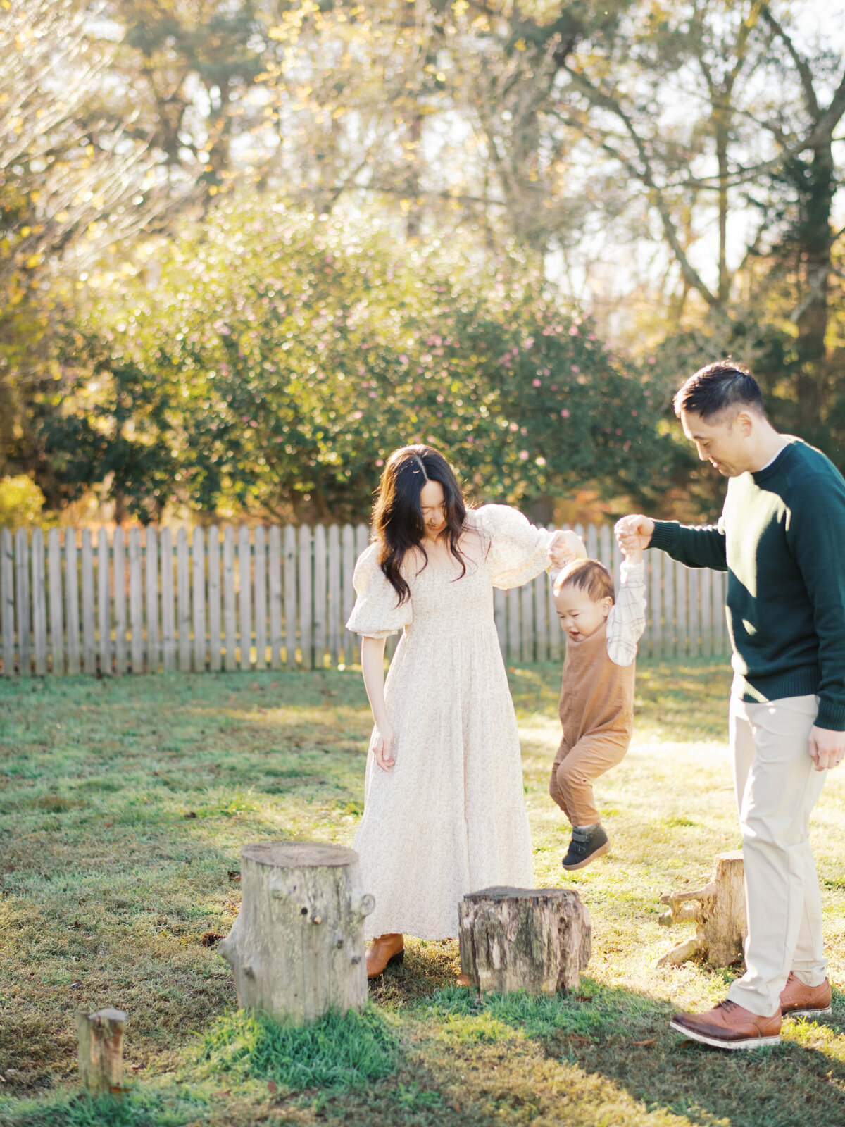 Parents play with their toddler son during a family session at Horseshoe Nature Preserve in Wake Forest NC. Image by Raleigh family photographer A.J. Dunlap Photography.