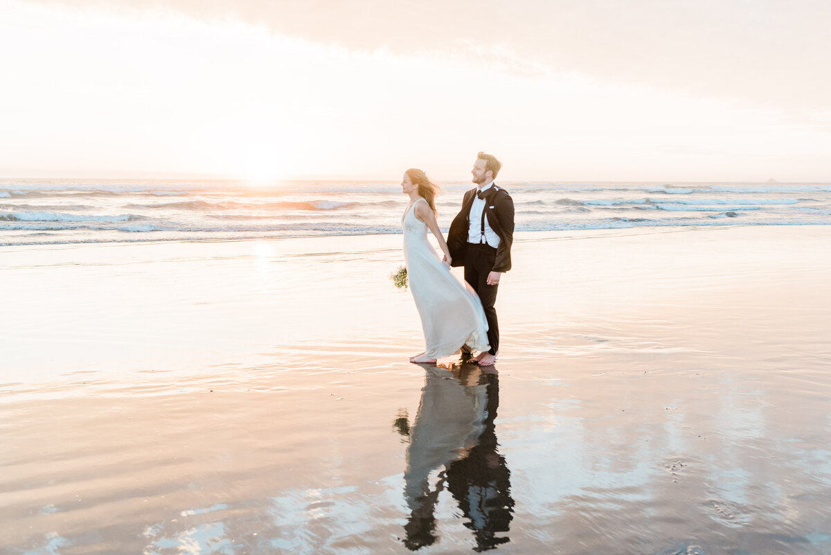 Couple on Beach watching sunset at Cannon Beach Oregon for their elopement.