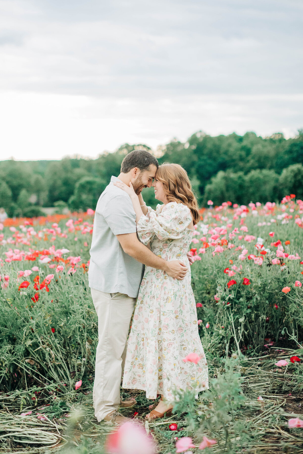 husband and wife in a field of flowers