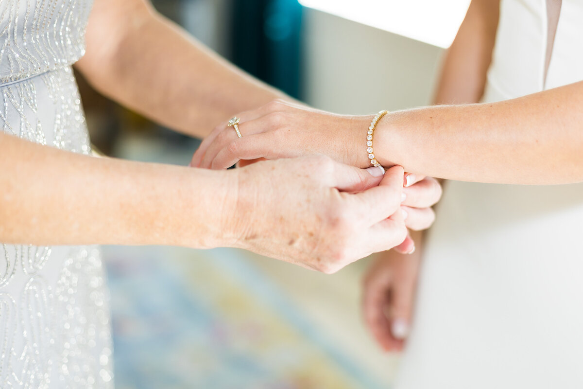 Bride having bracelet attached before wedding at  Tennessee State Museum