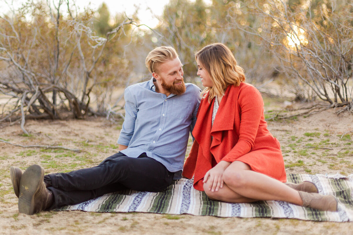 Cute candid golden hour desert engagement photos in Joshua Tree National Park CA by Joanna Monger Photography