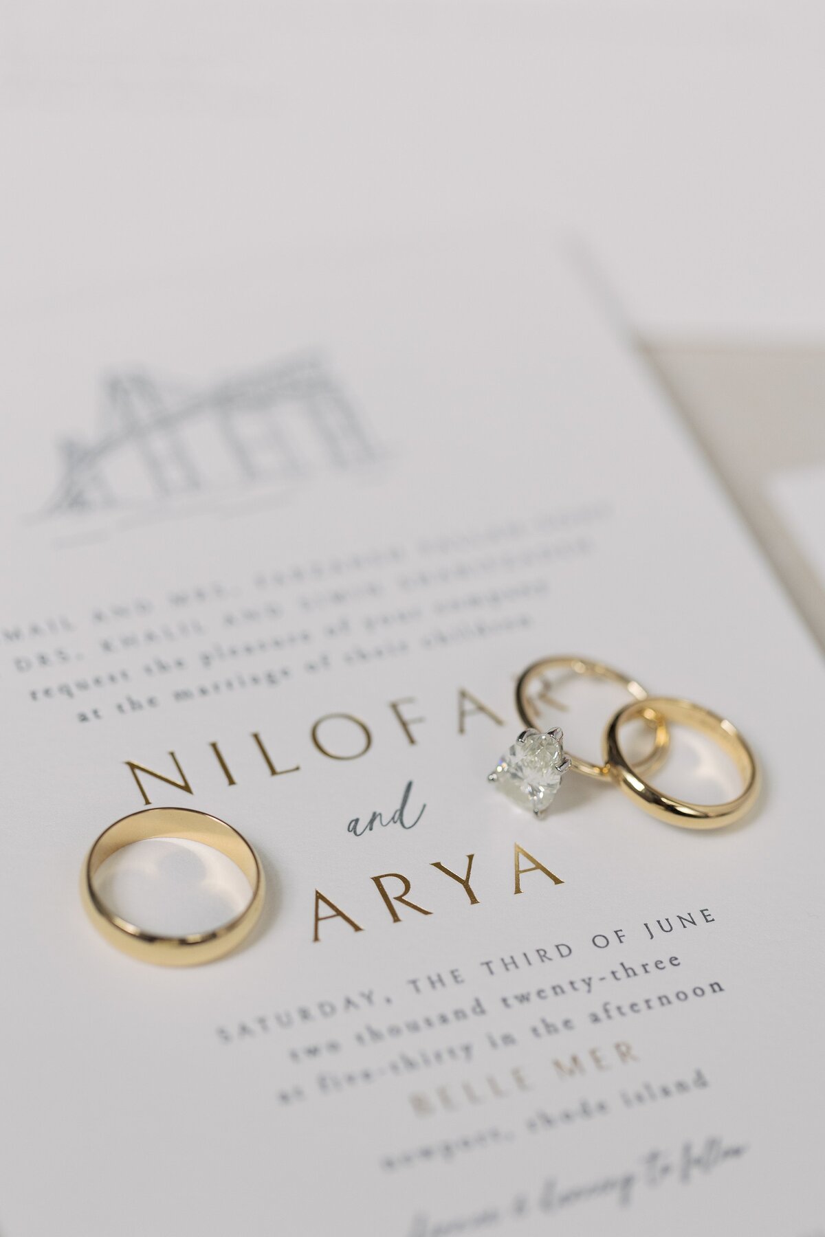 Close up detail of weddings rings on stationary.