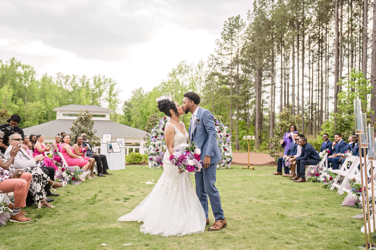 Newlyweds sharing a joyful dance in an open-air wedding celebration.