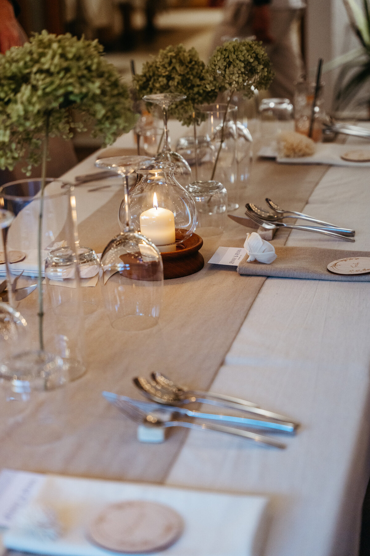 Reception table decor with candles and greenery