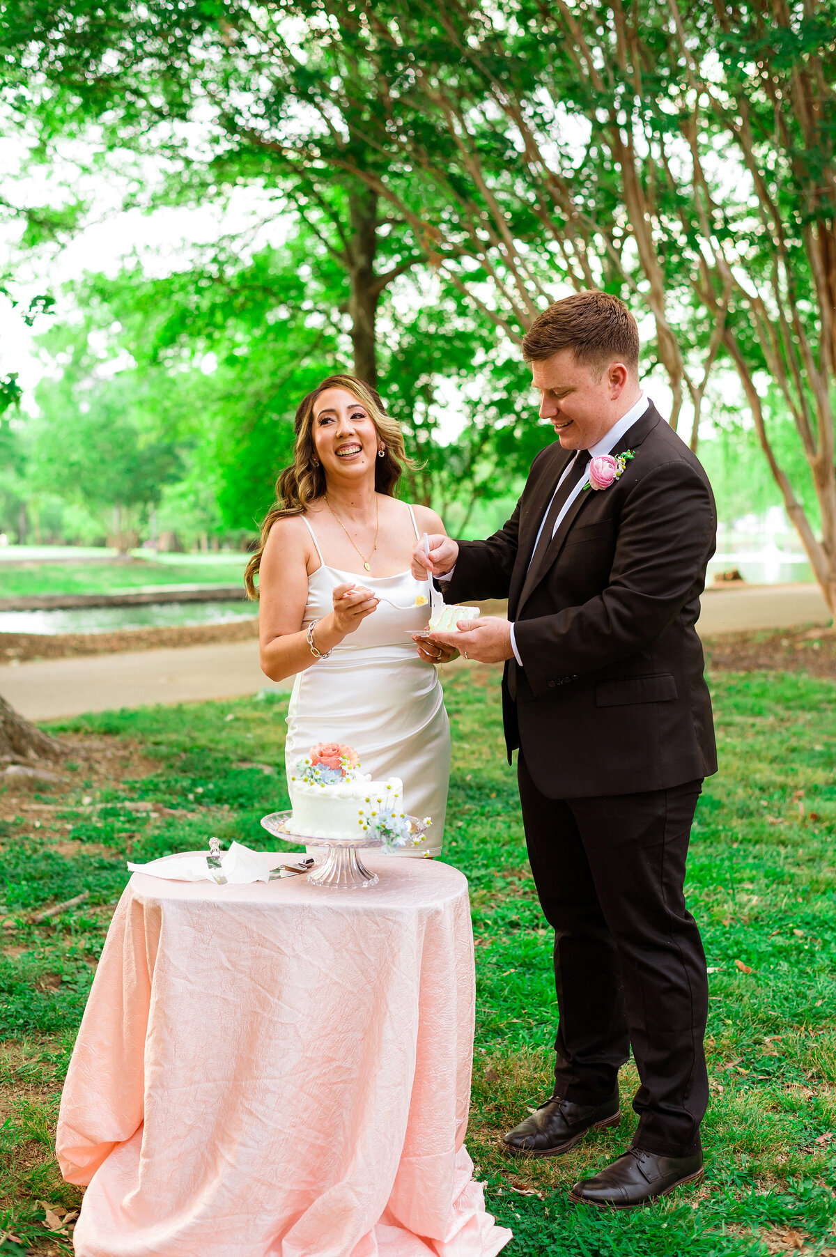 Bride smiling at guests during their micro wedding cake cutting