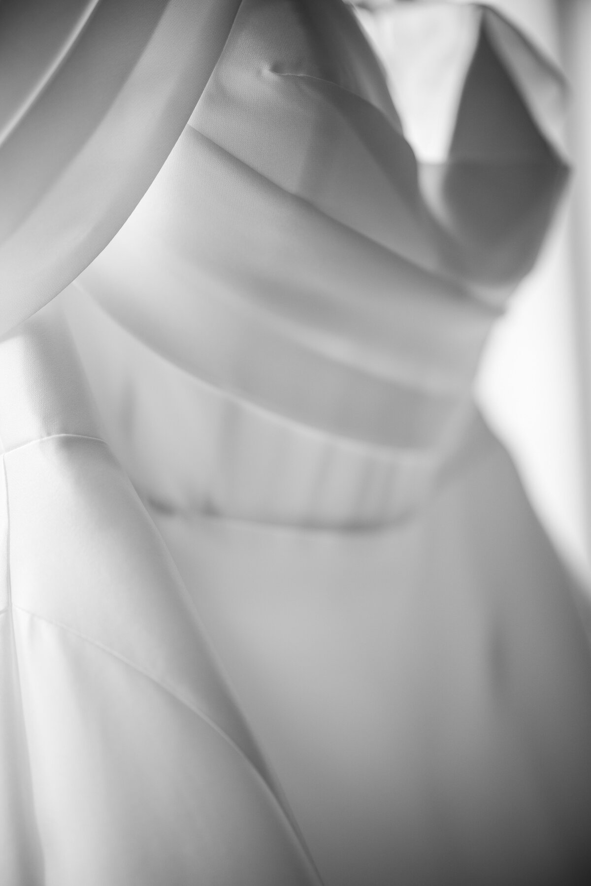 A wedding gown hangs in a window at a  Fairmount Park Horticulture Center wedding