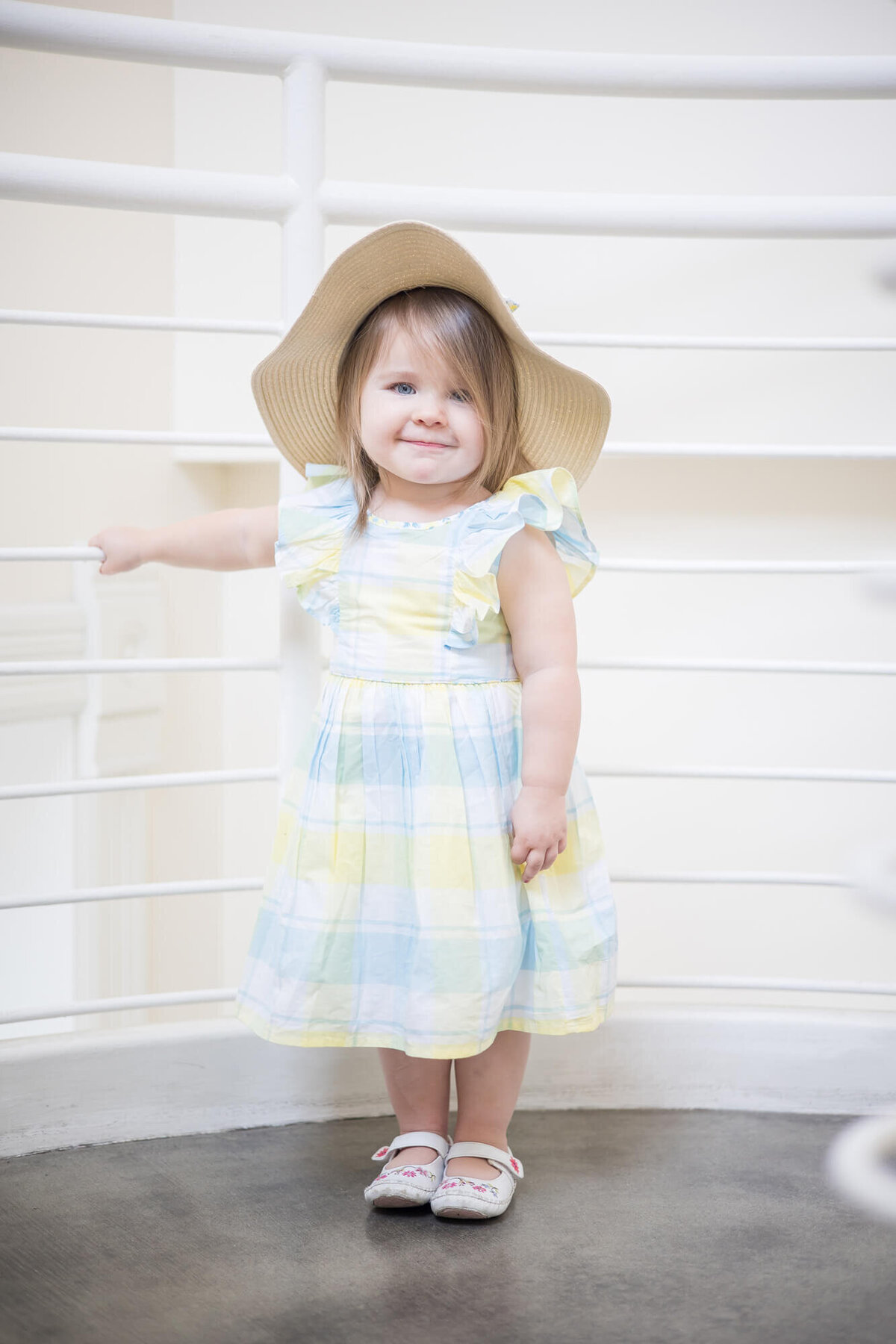 Grinning toddler girl standing for a portrait