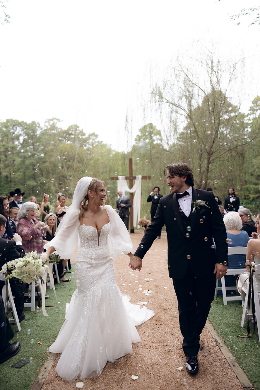 bride-groom-walking-down-aisle-married-emily-snyder-photography-texas-destinations