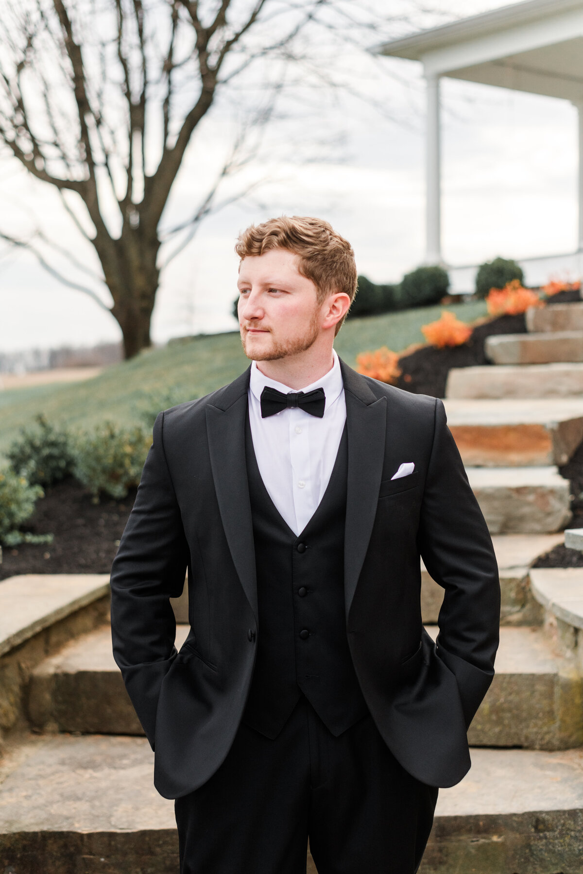 Groom poses for portrait at Pine Ridge Farm