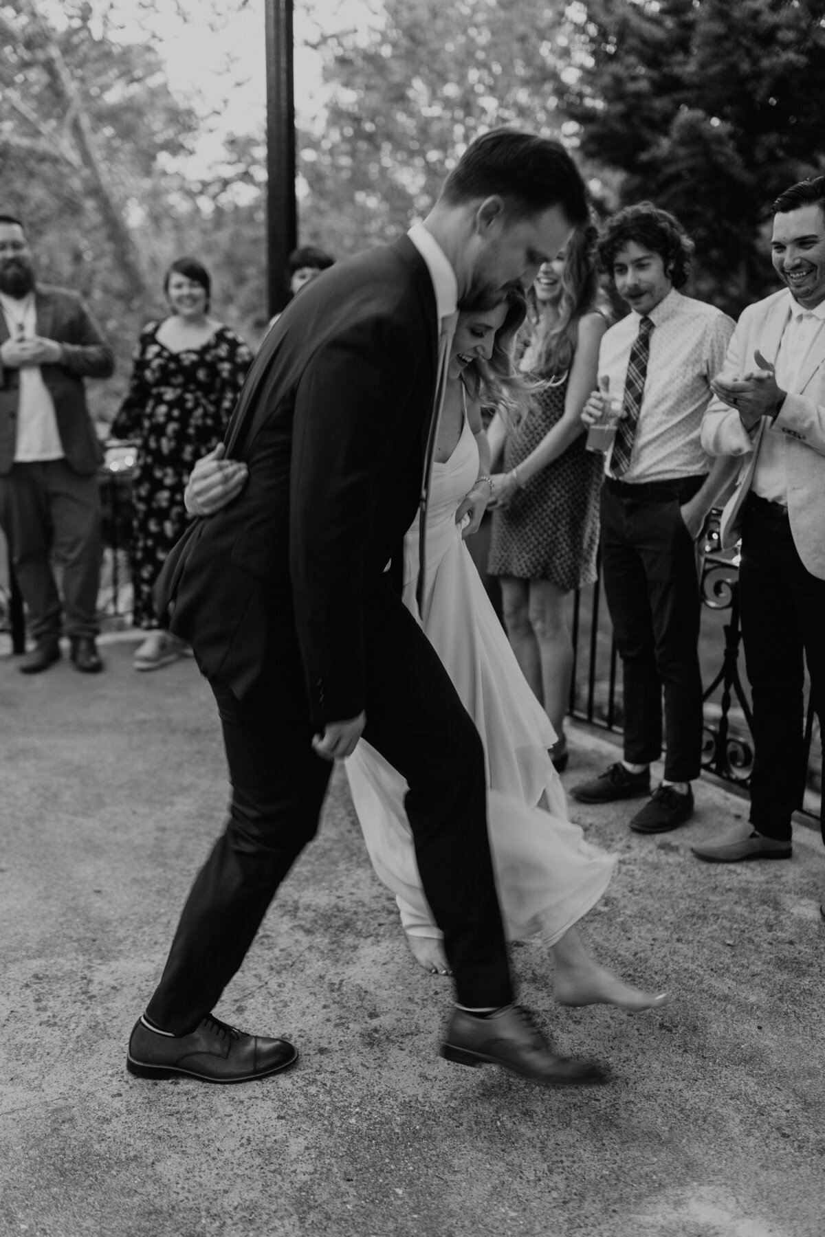 Black and white image of couple dancing at their outdoor reception at Lalumondiere Mill & Rivergardens